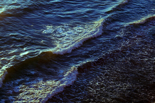 Photos of sea waves moving at sunset