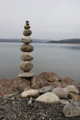stack of stones on the beach. Various stones top view on the beach. Stone Tower, Land Art, Installation, Stones. stones in balance. Mindfulness themed photo.