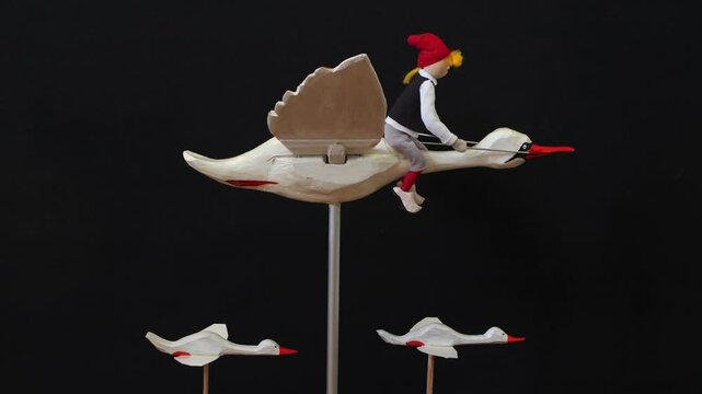 little boy Nils flying on a white goose, stop motion