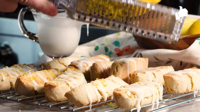 Making lemon biscotti to have with coffee.  Baking fresh lemon cookies made with ingredients like lemon, flour, sugar, eggs, vanilla and topped with a lemon glaze.