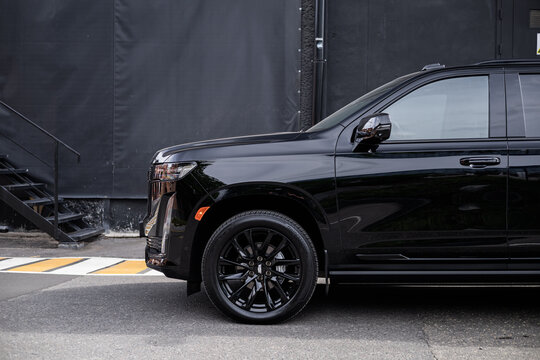car in the street road Black Cadillac Escalade Luxury Full-Size SUV logo detail