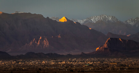 Sunrise view of a the ancient city of Yazd, Iran with a background of mountains in winter.  © The Lumenist