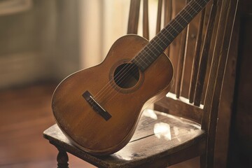 Naklejka premium A weathered acoustic guitar rests on a wooden chair