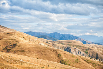 Majestic mountains of Armenia under a blue sky filled with clouds
