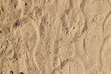 A close view of the dirty dirt ground surface.