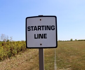 A close vie of the black and white starting line sign.