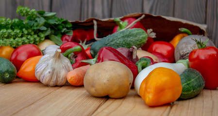 Fresh Organic Vegetables in Paper Bag on Wooden Background