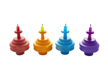 Colorful spinning tops with candles, showcasing vibrant hues in a playful arrangement against a bright background isolated on transparent background