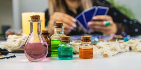 Woman fortune teller prepares a potion. Selective focus.