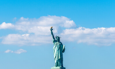 World famous Statue of Liberty under a blue sky with cloud