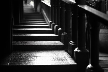 Grayscale perspective of a corridor with columns and shadows