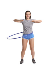 Smiling woman training with hula hoop on white background