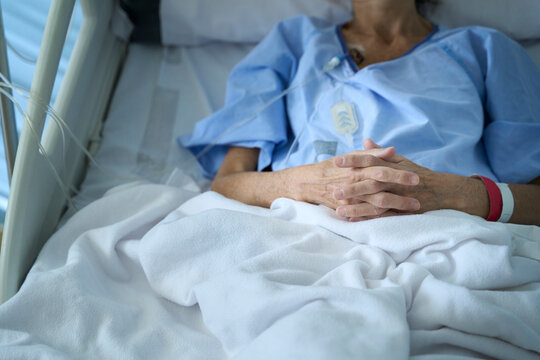 Senior female patient on hospital bed after cancer surgery
