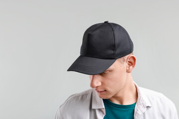 Man in stylish baseball cap on light grey background. Mockup for design