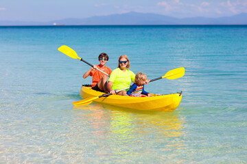 Kids kayaking in ocean. Family in kayak in tropical sea
