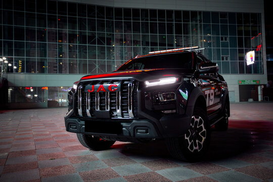 car in the night city JAC T9 off road vehicle 4x4 blacb logo detail