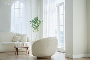 Stylish loft bedroom interior. Spacious design apartment with light walls large windows white couch...