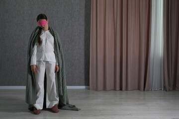 Young woman suffering from sleepwalking at home, space for text