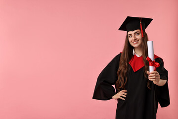 Happy student with diploma after graduation on pink background. Space for text