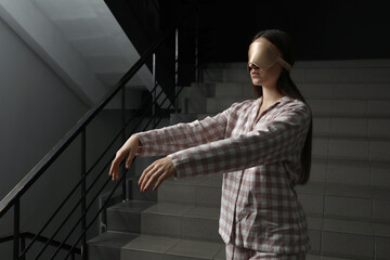 Woman suffering from sleepwalking on stairs indoors