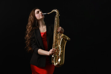 Professional musician playing saxophone on black background