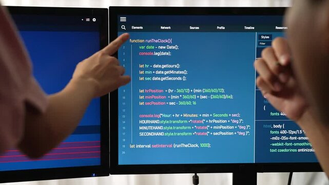 Slow motion back end software developer engineer for computer programming working together on debugging writing computing code, solving complex algorithms display on monitor in office. Burgeoning