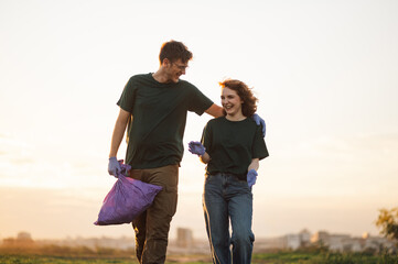 Two volunteers walking and talking after picking up trash