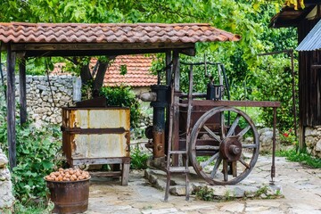 Obraz premium Ancient Nut Press A historical nut oil press in a rustic village setting
