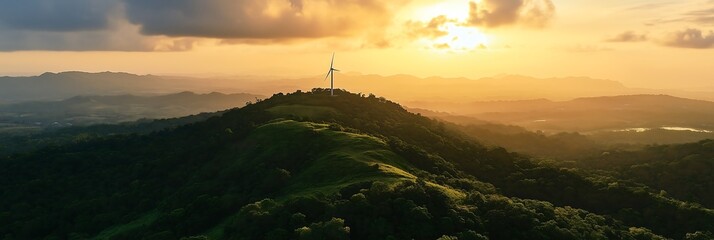 A stunning sunset over a mountainous landscape featuring a wind turbine amid lush greenery.