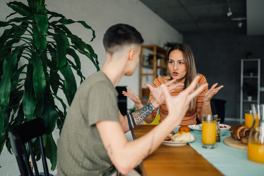 Lesbian couple arguing during breakfast at home - Powered by Adobe