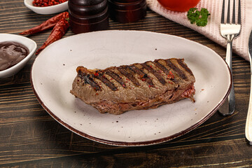 Grilled beef striploin steak with sauce