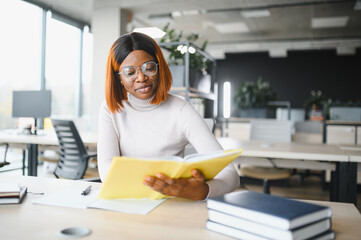 african american girl student studying at university at desk. Concept of higher education