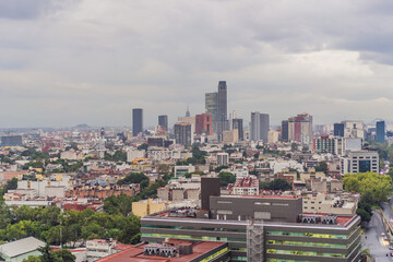 Naklejka premium Panoramic view of Mexico City from above, showcasing the sprawling urban landscape, iconic landmarks, and vibrant culture. Cityscape, travel, and architecture concept