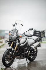 A large black touring motorcycle is covered in snow. The end of the motorcycle season, winter. The inscriptions "Stupid snow, No, WTF" symbolize stubbornness and the desire to continue traveling