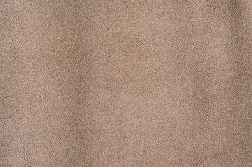 Beige background genuine leather suede macro photo.