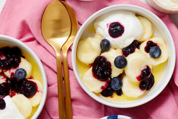Lazy cottage cheese dumplings with blueberry sauce, sour cream and butter.top veiw