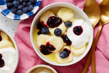 Lazy cottage cheese dumplings with blueberry sauce, sour cream and butter.top veiw