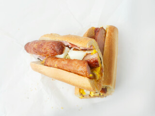 Traditional Irish breakfast roll with white bread, sausage, bacon or rasher, fried egg and black...