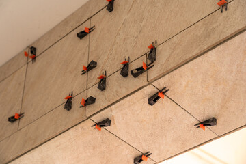 Tile leveling system with plastic clips and wedges, shot while the tile mortar sets.