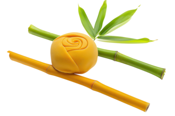 A vibrant yellow sweet delicacy shaped like a rose resting among fresh bamboo stalks in a bright, inviting setting isolated on transparent background