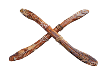 Intricately carved wooden sticks cross each other, showcasing detailed craftsmanship and cultural artistry against a minimalistic backdrop isolated on transparent background