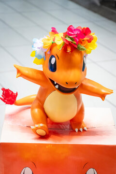 Pokemon Charmander character wearing a Hawaiian flower lei, on display at the Waikiki International Market Place.