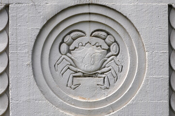 Crab stone carving with detailed craftsmanship in a circular pattern