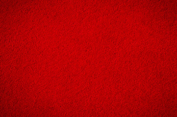 Red suede with darkening along the edge. Suede macro as a background.