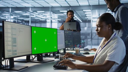 System administrator in server hub ensuring data remains shielded from potential threats using...
