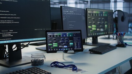Fototapeta premium Close up of headphones left by worker on server room PCs used by employees working to ensure minimal downtime. Equipment in data center workplace used for monitoring performance