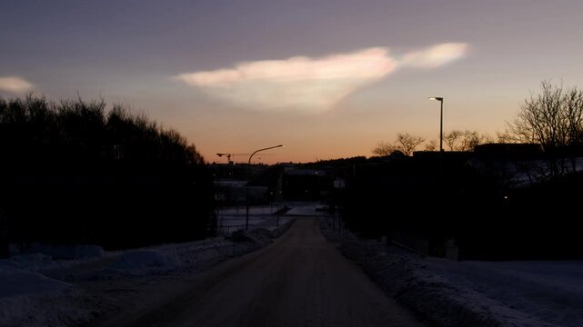 Nacreous polar stratospheric clouds over snowy road Reykjavik Iceland