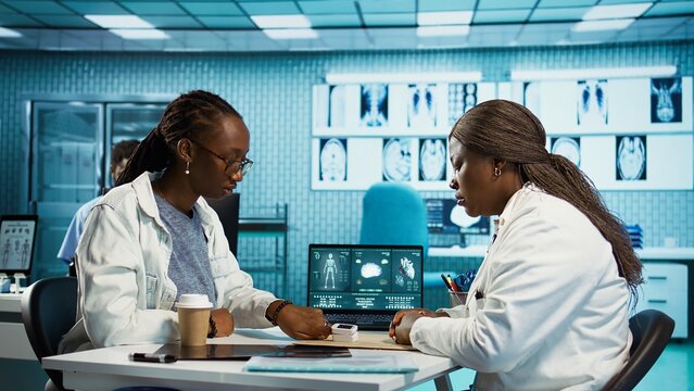 Health specialist measuring the oxygen saturation and pulse rate using oximeter during routine checkup, consult a black girl patient with modern medical tools. Vital signs measurement. Camera B.