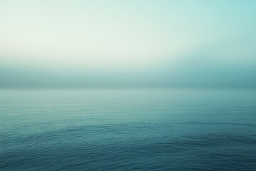 Obraz premium Tranquil Seascape at Dawn with Soft Mist Over Calm Waters and Gentle Waves in the Background