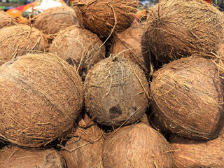 Fresh coconuts piled high at a vibrant market in the tropics